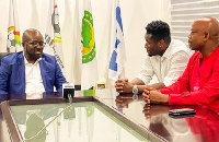 Asamoah Gyan with his manager and Kurt Okraku