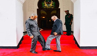 President John Magufuli (R) exchanging a foot greeting with opposition politician