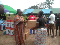 Naana Eyiah Quansah, MP for Gomoa Central hands over sewing machine to a beneficiary