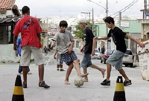 A photo of children playing football on the street