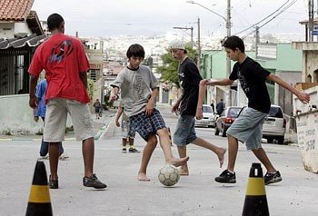 A photo of children playing football on the street