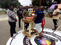 Some members of the Golden Arms about to engage in an armwrestling exercise at the event