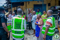 AMA officials in front of one of the shops