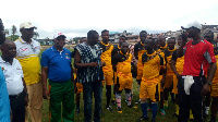 Tarkwa-Nsuaem Municipal Chief Executive, Gilbert Ken Asmah on the field with some of the teachers