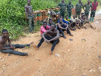 Suspects sitting on the ground