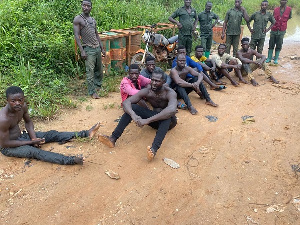 Suspects sitting on the ground