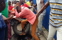 The suspect being beaten by the angry mob