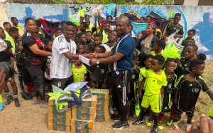 Kwasi Appiah making the donation to the football academy