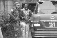 Gen Katumba Wamala and his bodyguard at the scene. Photo | Courtesy