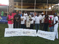 The winners displaying their trophies and dummy certificates with captain and sponsors