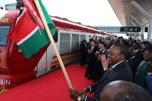 Uhuru Kenyatta, President of Ghana holding the country's flag