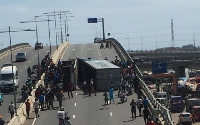 The truck lay in the middle of the road whilst Security personnel tried to curl the situation