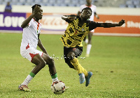 A Ghanaian player (right) attempts to go past an opponent