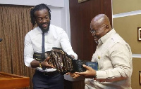 Kofi Kingston presents the WWE belt to Akufo-Addo