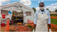 Medical worker stands in front of a ward of a Cholera Treatment Centre in Malawian capital Lilongwe