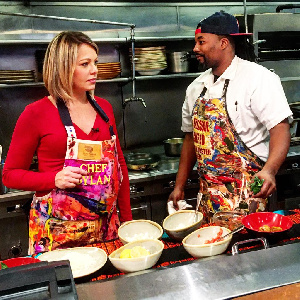 Hass Kwame And Another Celebrity Wearing His Apron Hand Painted Work.