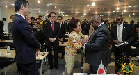 President Akufo-Addo interacting with an official at the GIPC JETRO Summit