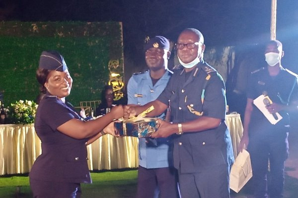 Chief Revenue Officer Geoffrey Oduro Kwaasi (right) presents an award to an officer