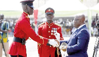 President Akufo-Addo presents an award to a cadet officer