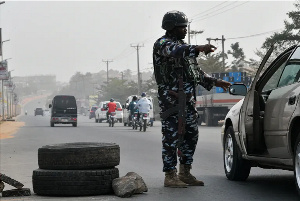 A Police Officer Mans A Checkpoint In Anambra State.png