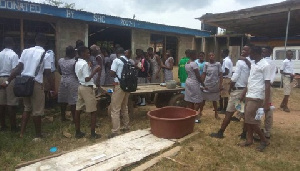 The School lacks desks forcing at least four students to share a desk.