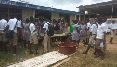 The School lacks desks forcing at least four students to share a desk.