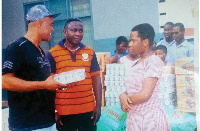 Mr. Thomas Asante, Chairman of GFA Columbus Ohio (L) presenting the items to Princess Mensah