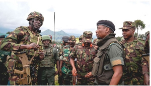 Kenya army Col Denis Obiero (left) talks with M23 spokesman Willy Ngoma in Kibumba