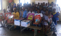 Anthony Kwaku Amoah in a group picture with pupils of the school