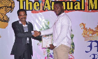 Jason Dzata receiving an award