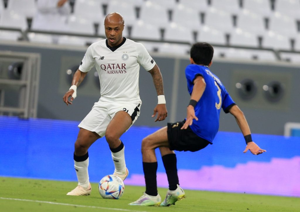 Andre Ayew (in white jersey) attempts to dribble past his opponent