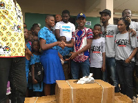 Abraham Attah presenting the items to school children in the Northern Region