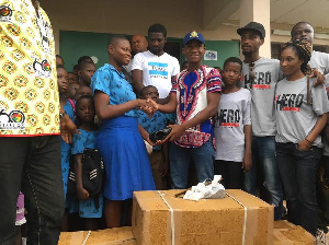 Abraham Attah presenting the items to school children in the Northern Region