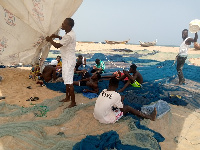 The fishermen mending their nets