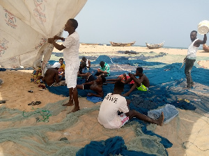 The fishermen mending their nets