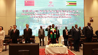 President Emmerson Mnangagwa (C), Chinese delegates (L) and other officials