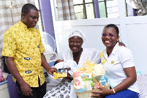 Charles Osei-Akoto, Regional Technical Head Northern Business District, presenting a hamper