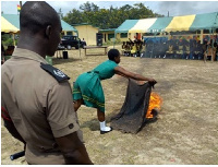 A student carrying out a demonstration on dousing fire