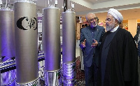 Iranian President Hassan Rouhani (R) had threatened to restart enrichment if sanctions continued