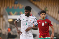 Black Stars midfielder, Thomas Partey and Morocco striker, Zakaria Aboukhlal(Red)