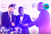 Kwadwo Asamoah receiving his award from GFA veep George Afriyie and a rep from the Italian Embassy