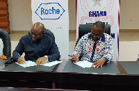 Dr. Philip Anderson and Dr. Frank Serebour signing the MoU