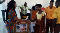 Ms Eunice Lasi in a handshake with a contestant