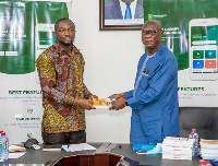 Daniel Owusu-Koranteng (right) presents copies of his books to the CEO of GLA