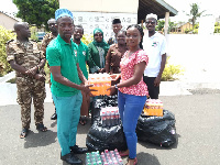 An officer receiving some of the donated items from GAMP president, Imam Seth Owusu