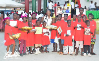 Miss Jackie Ricketts-Hagan (C) with some children