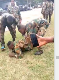 An army recruit being dragged on the floor in one of the training camps