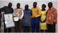 L-Hon. Dr. Mohammed Amin Adam presenting the awards to Mr. George Boadu with others looking on