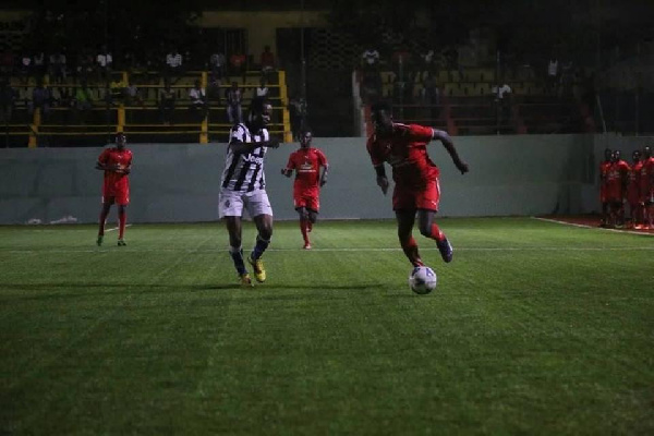 Striker Surak Musah takes on a defender in a game