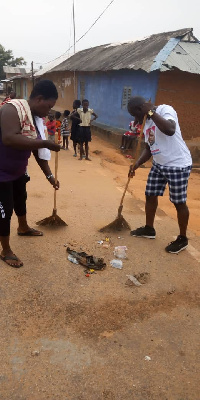 Team members sweeping the streets of Tikobo